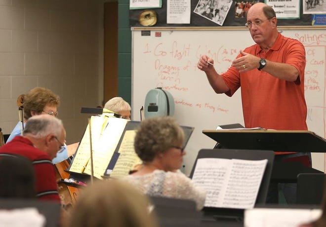 Eddy Rackley conducts practice for PC POPS on April 25 at Jinks Middle School. (Patti Blake | The News Herald)