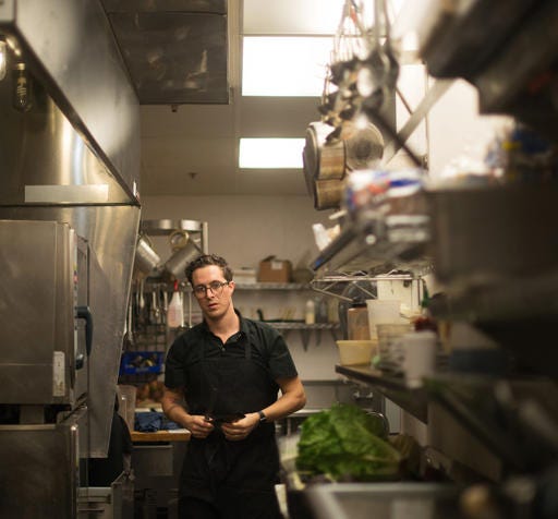 In this April 30, 2016 photo, chef Ray Roberts, who runs multiple Peoples Organic restaurants with his wife in the Twin Cities, prepares meals at his Edina, Minn., location. Roberts was the personal chef for music megastar Prince until he was found dead on April 21, 2016. "It felt like he wasn't himself probably the last month or two," Roberts said. "I think he was just struggling with being sick a lot." (AP Photo/Kevin Burbach)