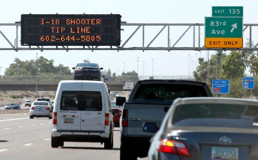 FILE - In this Sept. 11, 2015 file photo, a sign displays a shooter tip line above Interstate 10 in Phoenix. After weeks of random shootings on Phoenix freeways that rattled residents, police believed they had their man when they arrested Leslie Merritt Jr. Seven months later the entire case fell apart, leading to his release, the dismissal of charges and allegations of a botched investigation. (AP Photo/Ross D. Franklin, File)