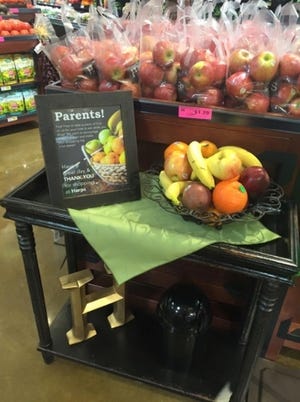 To underscore healthy eating lessons taught at home, Harps stores in Arkansas, Oklahoma and Missouri are offering a free peice of fruit to children as their caregivers shop. Photo courtesy Harps 
 Harps Foods program offers free apples, bananas and oranges to kids to encourage health eating habits.