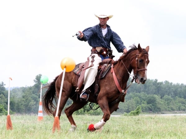 Bobby Pixley of Mulberry displays his riding and shooting skills in May 2014 during the Cowboy Mounted Shooting demonstration at the US Marshals Museum site. Times Record file photo