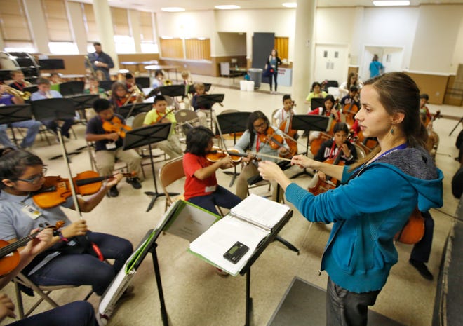 Kristen Swartley, conducts the Orquesta Nueva "New Orchestra" as they rehearse for Wednesday's El Sistema Oklahoma's spring concert. [Photo By Steve Gooch, The Oklahoman]