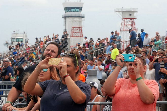 Air show attendees takes pictures with their phones Sunday at Cherry Point. A record 200,000 people attended the show.
