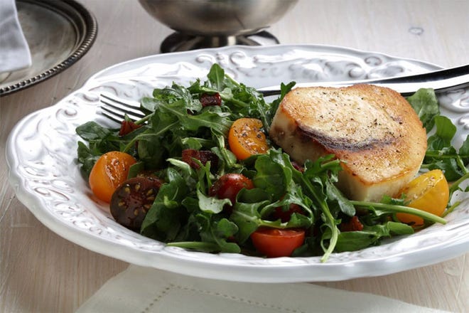 A slow bath in broth, then a quick pass through hot bacon fat keeps swordfish steaks tender while crisping the outside. A salad of arugula, tomatoes and bacon accompanies.