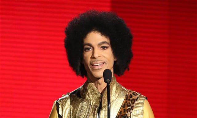 In this Nov. 22, 2015 file photo, Prince presents the award for favorite album - soul/R&B at the American Music Awards in Los Angeles.