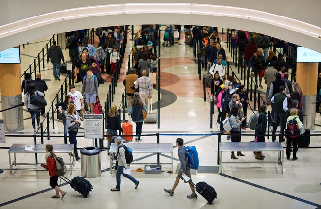 FILE - In this Nov. 25, 2015 file photo, travelers wait to go through a security checkpoint at Hartsfield-Jackson Atlanta International Airport in Atlanta. (AP Photo/David Goldman, File)