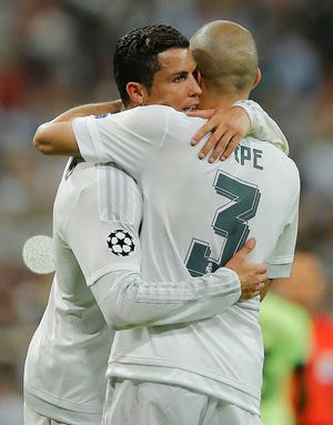 Real Madrid's Cristiano Ronaldo (left) embraces Pepe after their victory.