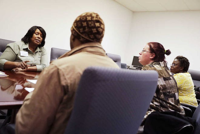 Sweet Tomatoes restaurant general manager Valerie Zimmerman (background) interviews job candidates at an event at the Georgia Department of Labor in Atlanta.
