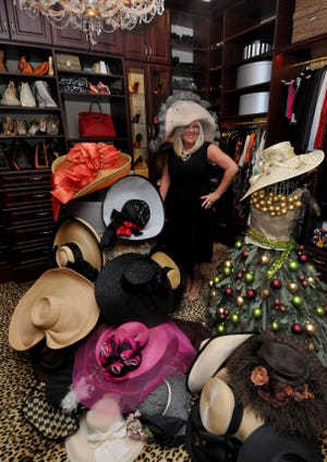 Linda Sliwowski stands in her closet with a collection of hats she has worn to previous Kentucky Derbys.