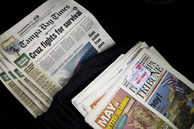 The Tampa Bay Times and the Tampa Tribune are displayed together during a press conference on Tuesday regarding the sale of the Tribune to the Times