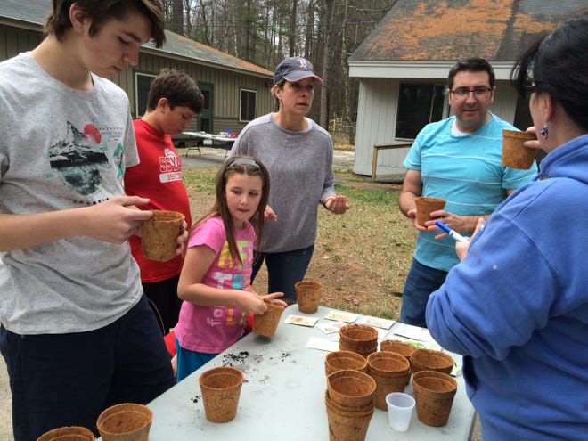 The Signore family and friends plant seeds in compostable seed starters to "Spring Into Planting" for the Earth Day event at the TREE Center in April. COURTESY PHOTO BY MEAGHAN AYER
