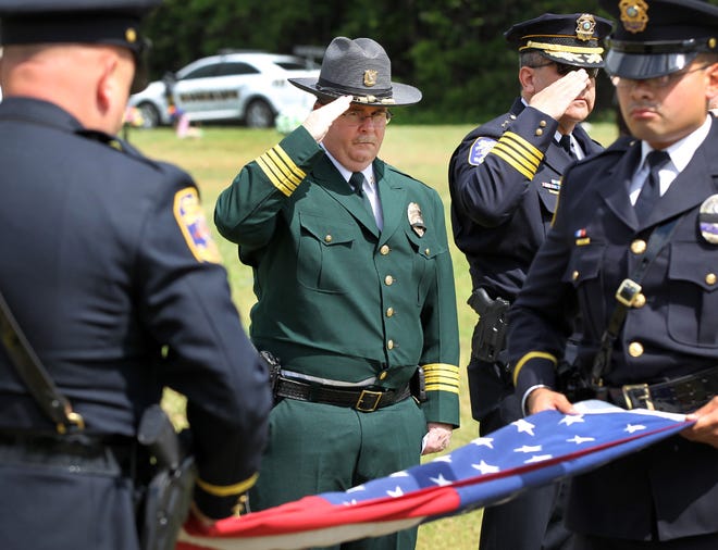 Gaston County Police Chief Joseph Ramey salutes as the colors are retired during a wreath-laying ceremony Wednesday morning at Gaston Memorial Park to honor fallen law enforcement officers. JOHN CLARK/THE GAZETTE