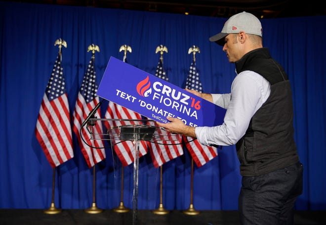 A worker for Republican presidential candidate Sen. Ted Cruz, R-Texas, removes the campaign sign from the podium following primary night campaign event in Indianapolis, Tuesday, May 3, 2016. Cruz ended his presidential campaign, eliminating the biggest impediment to Donald Trump’s march to the Republican nomination. (AP Photo/Michael Conroy)