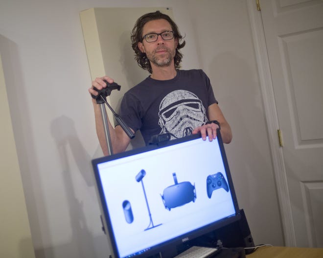 Christian Cantrell, 42, a software engineer and science fiction author, has a high-end computer and tripod set up for an Oculus Rift device. He pre-ordered the gadget months ago and is still waiting for it. AP/Pablo Martinez Monsivais
