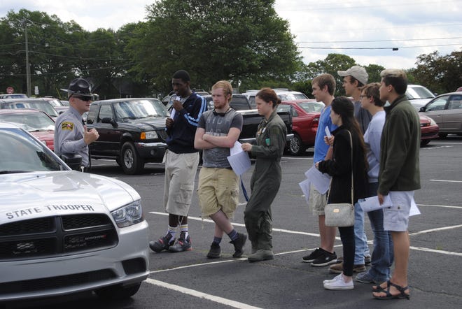 Burns High School students listen to N.C. Highway Patrol Trooper R.R. Hall, far left, speak on Wednesday about the dangers of distracted driving. Joyce Orlando/The Star