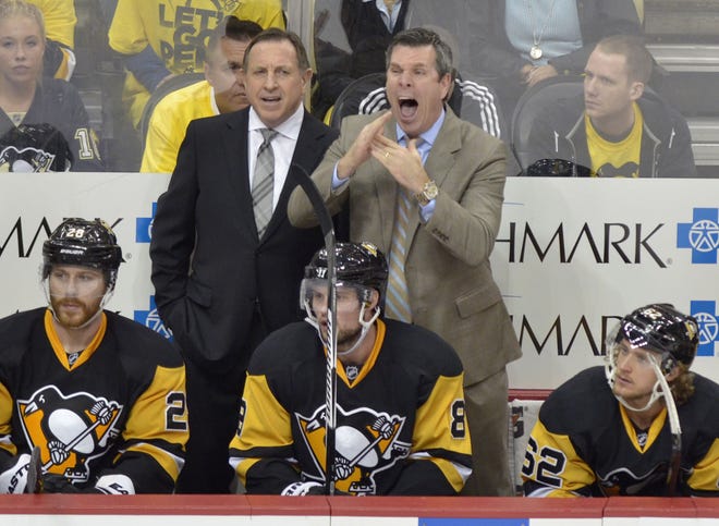 Penguins coach Mike Sullivan, standing at right, tries to signal for a timeout during the third period of Wednesday's Game 4 against the Capitals in the Eastern Conference Semifinals at Consol Energy Center in Pittsburgh.