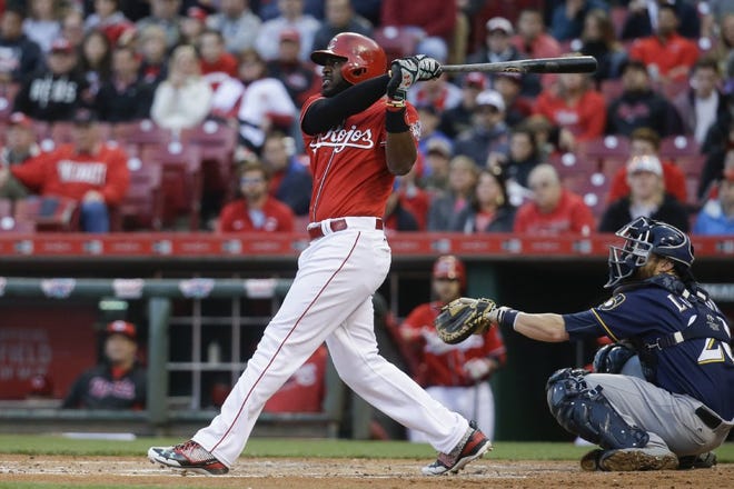 The Reds' Brandon Phillips hits a two-run home run off Brewers starting pitcher Chase Anderson in the second inning.