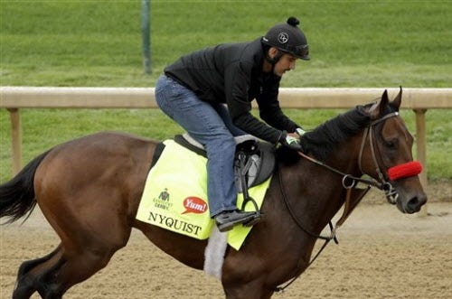 Exercise rider Jonny Garcia rides Kentucky Derby hopeful Nyquist during a workout at Churchill Downs Tuesday, May 3, 2016, in Louisville, Ky. The 142nd running of the Kentucky Derby is scheduled for Saturday, May 7.