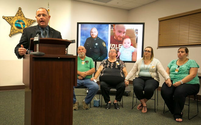 Marion County Sheriff's Office Lead Detective Zachary Hughes, left, speaks about the Ronnie Damon case as Ronnie's family, father Gary Damon, second from left, mom, Sandra Damon and sisters Carrie Kelley and Sandra Damon, hold hands during the press conference Friday. The family spoke briefly to the media Friday afternoon, May 6, 2016, asking for help from the public to bring Ronnie's killer to justice. Sheriff Chris Blair also spoke about the case. The Marion County Sheriffs Office is doing a campaign on Facebook asking for information about unsolved homicide of Damon. Ronnie, former MCSO Corrections Officer, was shot and killed in his driveway while he was working on his car evening of Jan. 6, 2016.
