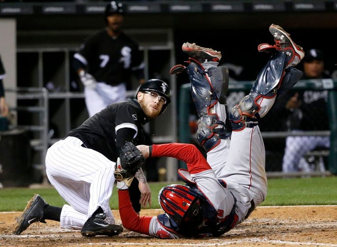 Chicago White Sox's Brett Lawrie, left, tries to score on a sacrifice fly by Austin Jackson but is called out on a throw from Boston Red Sox right fielder Mookie Betts to catcher Ryan Hanigan during the fifth inning of a baseball game Thursday, May 5, 2016, in Chicago. The play was upheld after video review.