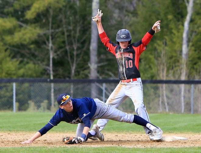 Exeter High School second baseman Cody Morissette, bottom, tries to keep contact with the bag as Bedford's Joey Barrett reaches second base during the fourth inning on Friday. Barrett was ruled safe on the play, a critical ruling that allowed Bedford to rally for a six-run inning in its eventual 8-6 win over Exeter.