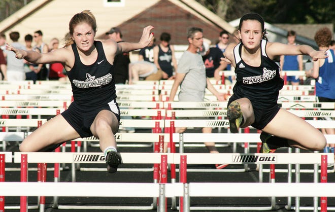 Lindsey Brown of Annawan-Wethersfield, left, and Allison Meyer of Ridgewood battle to the finish line in the 100-meter hurdles at Friday night’s LTC meet.