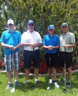 The winning team includes, from left, Jacob and John Cameron, and Ian and Bobby Ball.