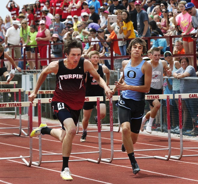 Axel Jones, left, of Turpin High School wins Class A 110 meter hurdles event with a 15.16 time. Class A-2A boys and girls state championship track meet at Carl Albert High School on Saturday, May 7. [Photo by Jim Beckel, The Oklahoman]