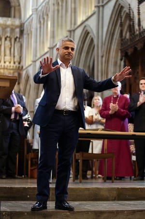 London's new mayor Sadiq Khan gestures during the official signing ceremony in Southwark Cathedral, London, Saturday May 7, 2016. On Friday the 45-year-old Labour Party politician became the first person of Islamic faith to lead Europe's largest city. (Yui Mok/Pool via AP)
