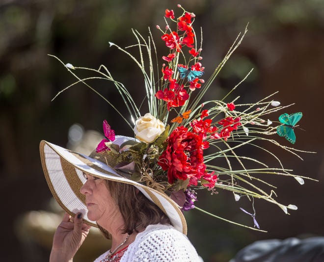 Dru Spinuzzi keeps a hand on her hat to keep it from blowing away while attending the Posada Kentucky Derby party a the Orman Mansion Saturday afternoon May 7, 2016 in Pueblo, Colo. The event was a fund raiser for the nonprofit which supports Pueblo's homeless residents. (Bryan Kelsen, The Pueblo Chieftain)