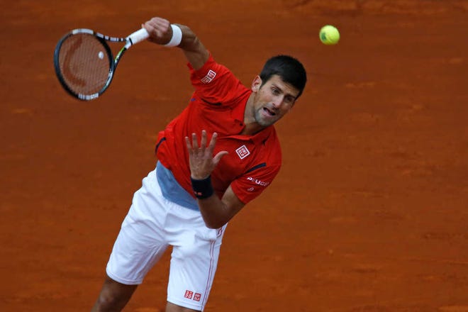 Novak Djokovic serves to Andy Murray during their Madrid Open tennis final match on Sunday in Madrid, Spain. Djokovic won 6-2, 3-6 and 6-3. (AP Photo/Francisco Seco)
