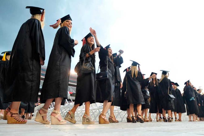 Graduating students cheer during the processional portion of the spring commencement ceremony at the University of Georgia in Athens, Ga., Friday, May 9, 2014. (AJ Reynolds/Staff, @ajreynoldsphoto)