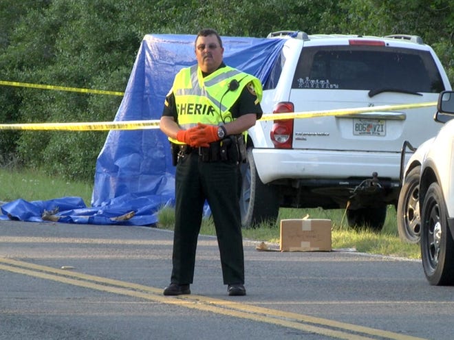 A Marion County sheriff's official guards the scene of a fatal shooting in Hog Valley on Monday afternoon.