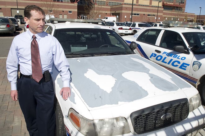 CHIEFTAIN PHOTO/FILE Service Bureau Capt. Brett Wilson shows one of many Pueblo police cars in need of a paint job in 2014. These cruisers may be a thing of the past after police received the go-ahead to purchase 22 new vehicles.