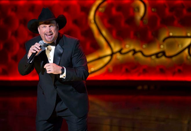 FILE - In this Dec. 2, 2015 file photo, Garth Brooks performs during the Sinatra 100 - An All-Star Grammy Concert at The Wynn Las Vegas in Las Vegas. Brooks is set to perform in New York City for the first time in 19 years at Yankee Stadium this summer. The country star announced Wednesday, May 11, 2016, that he will play at the venue in the Bronx on July 9. (Photo by Eric Jamison/Invision/AP)