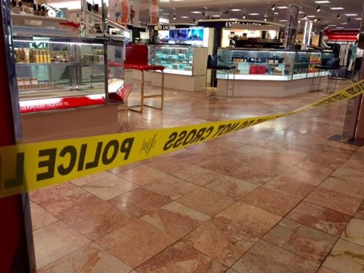 Crime scene tape is seen inside the Macy's at the Silver City Galleria mall in Taunton, Mass., Tuesday, May 10, 2016. Multiple people have been stabbed separate attacks at the mall and a home in Massachusetts.