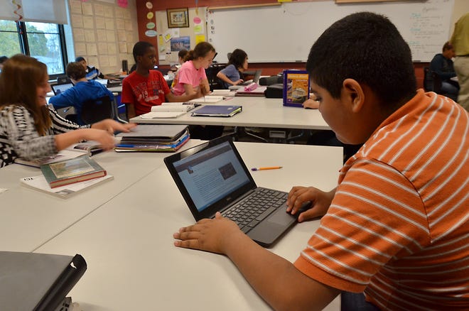 Students in a science class at Holland Heights Elementary use chrome books in their classroom as part of the 21 bond campaign. The bond passed in 2010. Sentinel File