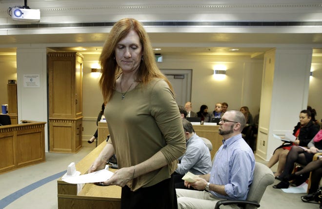 FILE - In this Wednesday, Jan. 27, 2016 file photo, Kathryn Mahan of Puyallup, who identifies as a transgender woman, stands up after testifying in opposition to a bill that would eliminate Washington's new rule allowing transgender people use gender-segregated bathrooms and locker rooms in public buildings consistent with their gender identity at the Capitol in Olympia, Wash. (AP Photo/Ted S. Warren)