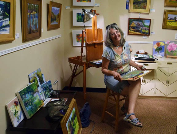Artist Susan Cheatham works in her studio in the CAW Arts Center on Broad Street in New Bern, one of the venues for ARTcrawl on Friday.