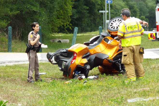 A state trooper investigates a crash that caused a trike to roll on State Road 11 near Lake Dias, killing one person. News-Journal/Patricio G. Balona