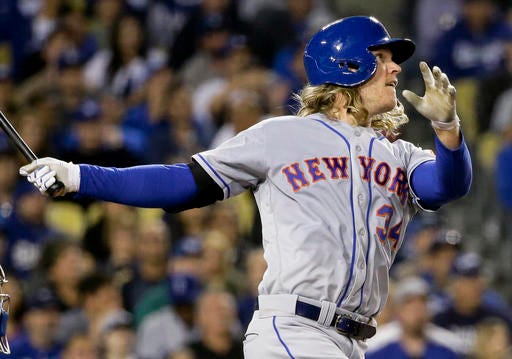 Noah Syndergaard watches his three-run home run during the fifth inning of a baseball game against the Los Angeles Dodgers in Los Angeles, Wednesday, May 11, 2016. (AP Photo/Chris Carlson)