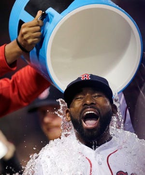 Jackie Bradley Jr. is doused with a bucket of ice water by teammates after a 13-3 win against the Oakland Athletics at Fenway Park in Boston, Wednesday, May 11, 2016. Bradley had two home runs and six RBI in the game.