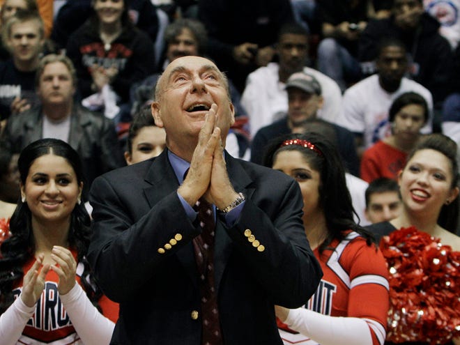 In this Dec. 5, 2011, file photo, basketball announcer Dick Vitale looks skyward during a court dedication in his honor at Detroit Mercy in Detroit. If you're a college basketball fan imagine how much fun it would be to exchange text messages with Dick Vitale. Instead of the texts being full of catchphrases, predictions and analysis, they are full of sobering stories. Stories about pediatric cancer. It is his passion and he wants to make sure he touches every vein that can bring more money for research.