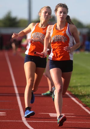 Madeline Campbell, taking a handoff from teammate Kennedy Duffy, runs the anchor leg of Rochester's winning 4x800-meter relay May 5 in the Central State Eight Conference Girls Track Meet. DAVID SPENCER/THE STATE JOURNAL-REGISTER