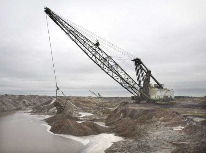 Two drag-lines operate together at a phosphate mine near Fort Meade.