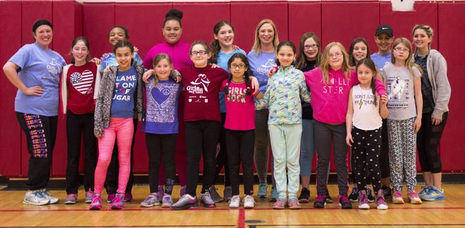 The "Girls on the Run" squad at Anna S. Kuhl Elementary School includes 14 girls with their coaches, ASK assistant principal Nicole Ey, music teacher Trish Halpenny, fourth-grade teacher Kim Eichele and high school student Hailey Pierce. Photo by Josh Conklin