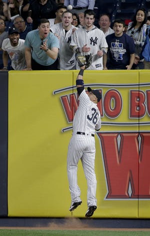 Yankees right fielder Carlos Beltran (36) makes a leaping catch at the wall on a ball hit by Kansas City Royals' Salvador Perez during the fifth inning of New York's 7-3 win on Thursday. Associated Press