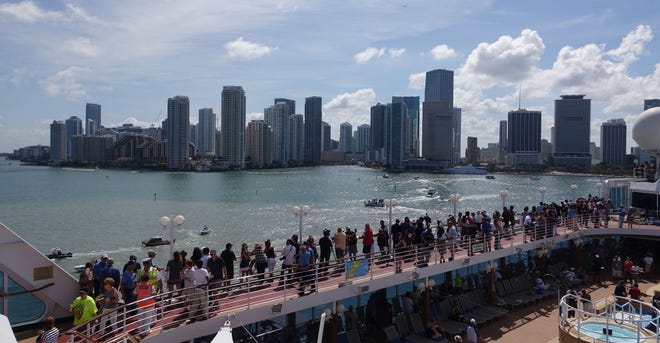 Passengers on board the Adonia watch as the ship leaves port May 1 in Miami, en route to Cuba. After a half-century of waiting, passengers finally set sail on an historic cruise to Cuba. Carnival’s Cuba cruises, operating under its Fathom brand, will visit the ports of Havana, Cienfuegos and Santiago de Cuba.