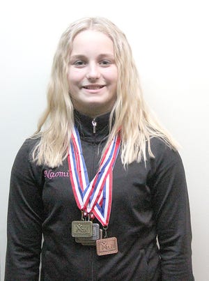Naomi Prater, of Jonesville, is pictured with a portion of her gymnastic medals. THOMAS BIESZK