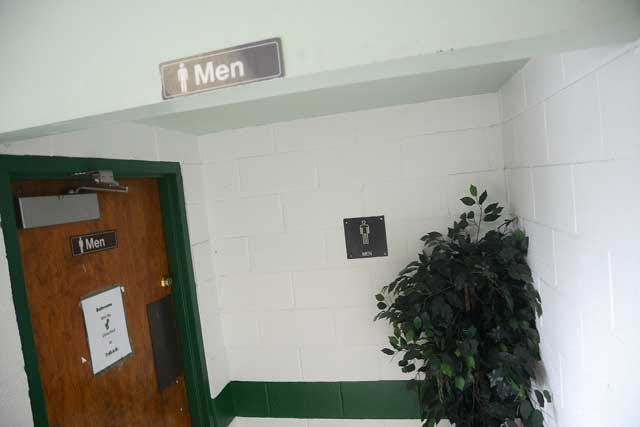 There are three signs posted identifying the men's restroom at North Lenoir High School on Friday. The signs have been in place for many years.